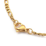 zoomed in golden lobster claw clasp on golden Figaro chain on white background. 