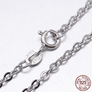 zoomed in section of sterling silver flat cable chain with spring ring clasp on white background. "real sterling silver 925" stamp in bottom right corner.