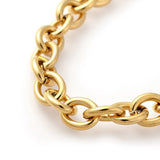 zoomed in section of golden cable chain bracelet on a white background. 