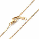 zoomed in sections of golden flat satellite curb chain necklace with lobster claw clasp on white background. 