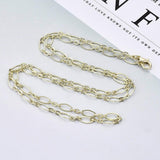 light golden oval cable chain necklace with lobster claw clasp on white and light gray background. 