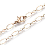 zoomed in sections of golden oval cable chain necklace with lobster claw clasp on white background. 