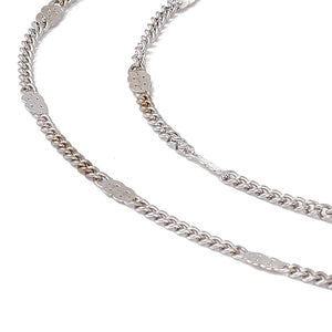 golden flat satellite curb chain with lobster claw clasp  and extender on  white background. 