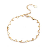 golden heart link bracelet with lobster claw clasp and extender chain with a heart charm on white background. 