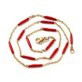 golden curb chain and red enamel bar link necklace with lobster claw clasp on white background. 