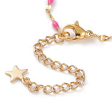 zoomed in section of , a lobster claw clasp and extender with a star charm on the end of the golden link bracelet making with pink enamel on a white background. 