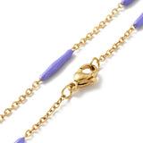 zoomed in sections of golden curb chain and purple enamel bar link necklace with lobster claw clasp on white background. 