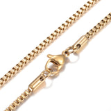 zoomed in sections of golden box chain necklace with lobster claw clasp on white background. 