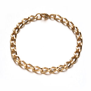 golden twisted chain bracelet with lobster claw clasp on white background. 