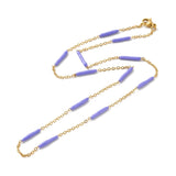 golden curb chain and purple enamel bar link necklace with lobster claw clasp on white background. 